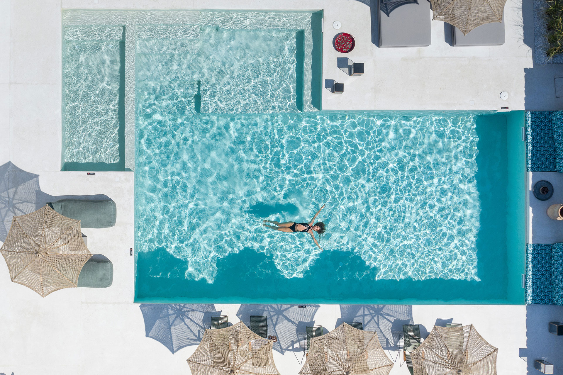 Koukoumi Vegan Hotel pool with sunbeds and umbrellas